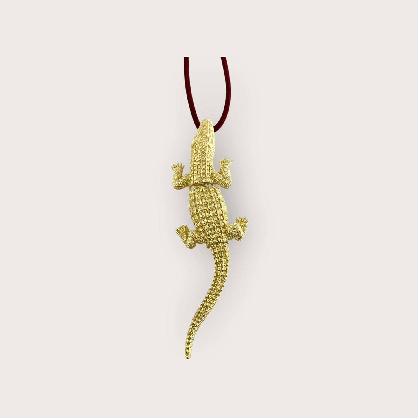 Crocodile on burgundy cord