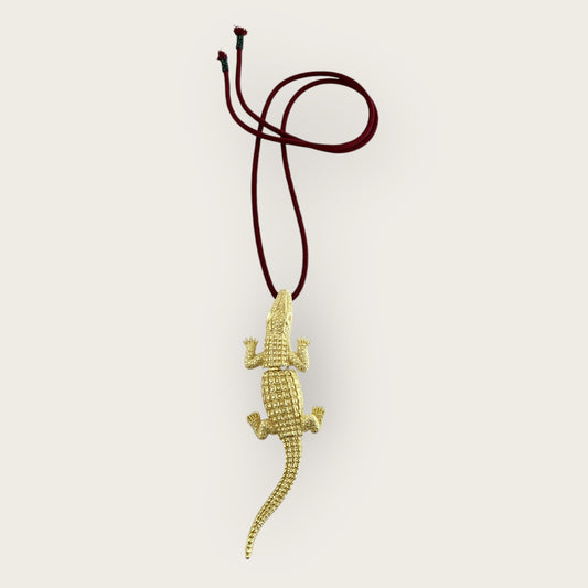 Crocodile on burgundy cord